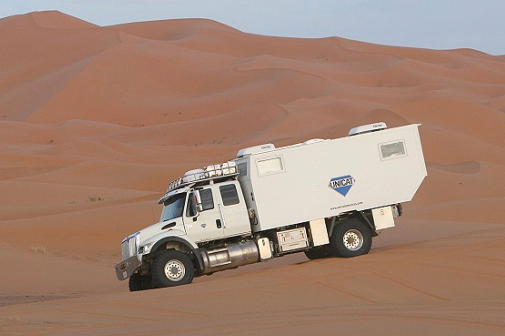 UNICAT expedition vehicle crossing desert dunes